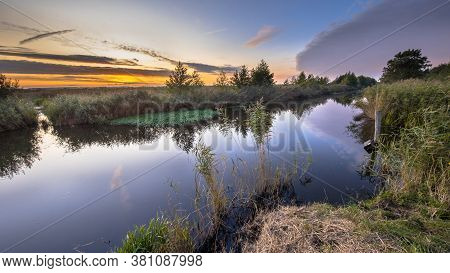 Sunset Over River In Dutch Nature Reserve Onlanden In Drenthe, Netherlands