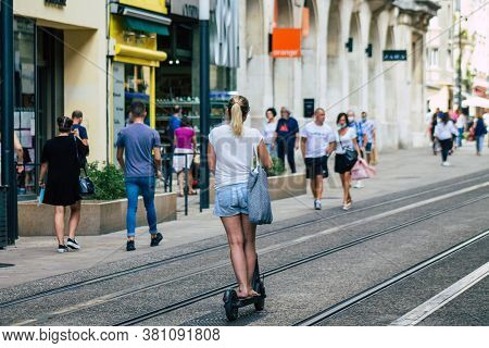 Reims France August 15, 2020 View Of Unidentified People Rolling With An Electric Scooter In The Str