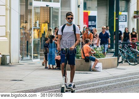 Reims France August 15, 2020 View Of Unidentified People Rolling With An Electric Scooter In The Str
