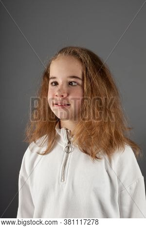 Cute Teenage Blond Girl In White Hoody With Slanting Eyes