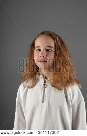 Cute Teenage Blond Girl In White Hoody With Slanting Eyes