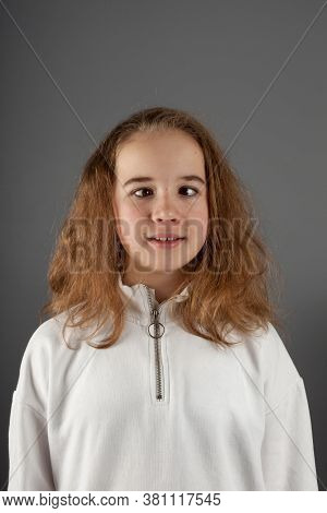 Cute Teenage Blond Girl In White Hoody With Slanting Eyes