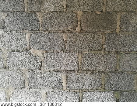 A Wall Made Of Cement Blocks And Concrete Like Texture.each Block Is Differentiated By The Concrete 