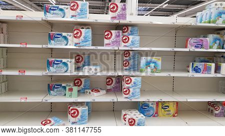 Half Empty Shelves With Toilet Paper Due To Coronovirus In A Supermarket