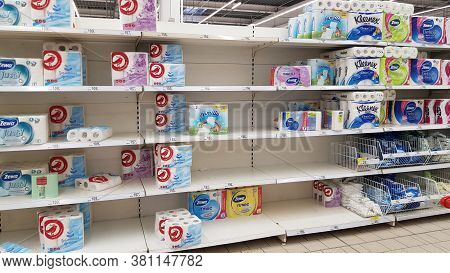 Half Empty Shelves With Toilet Paper Due To Coronovirus In A Supermarket