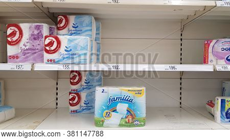 Half Empty Shelves With Toilet Paper Due To Coronovirus In A Supermarket