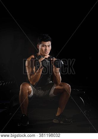 Handsome Man Raising Dumbbell,doing Exercise For Buit Muscle,fit And Firm Body,model Posing,blurry L