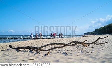 Rewal, Poland - September 05, 2019: Flotsam And Walkers On The Beach Of Rewal On The Polish Baltic S