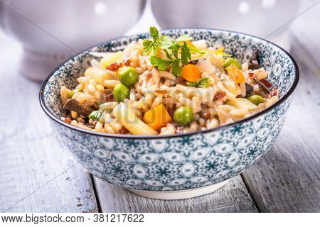 Risotto or cooked rice with mushrooms and vegetables