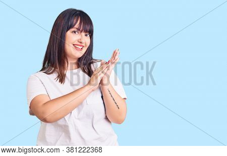 Young plus size woman wearing casual clothes clapping and applauding happy and joyful, smiling proud hands together 