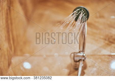 Showerhead In Bathroom. Shower Head With Blurred Hot Water Drops. Take A Fresh Contrast Shower For S