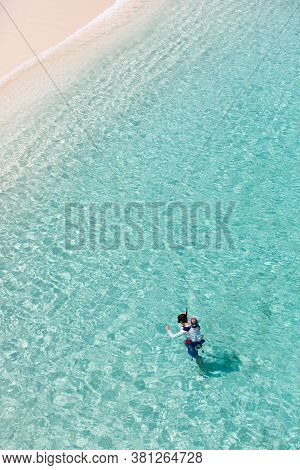 Aerial View Of Family Of Two, Father And Son, Snorkeling Together In Beautiful Caribbean Turquoise W
