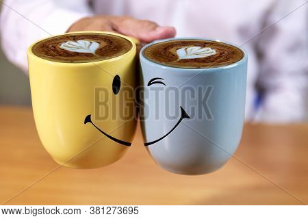 Close Up Hand Businessman Hold Coffee Cups With Smle Face Background. Hand Man Hold Yellow And Blue 