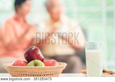 Fruit Cookie And Milk For Breakfast With Senior Couple On The Background For Healthy Elderly Lifesty
