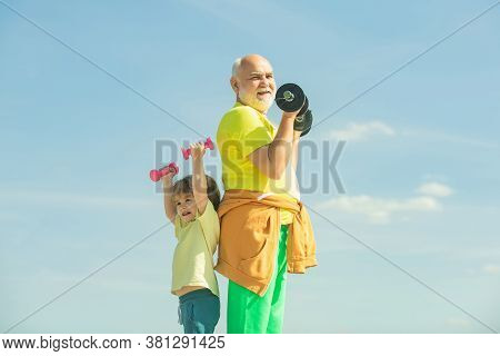 Motivation And Sport Example Concept. Senior Man And Child Exercising On Blue Sky. I Love Sport. Act
