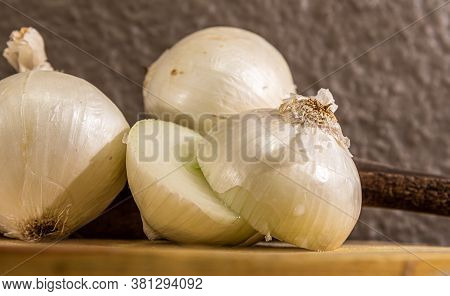 Tubers Of Onions (allium Cepa) Cut In Halves On Wooden Board