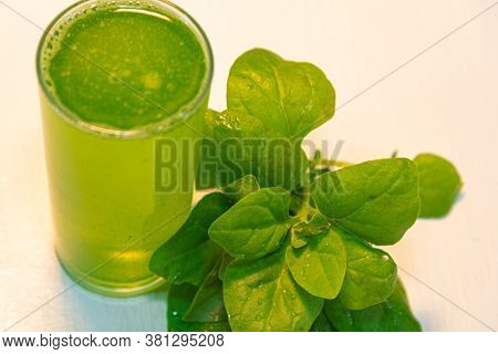 Top View Spinach Juice (spinacia Oleracea) On White Surface And Leaves See...
