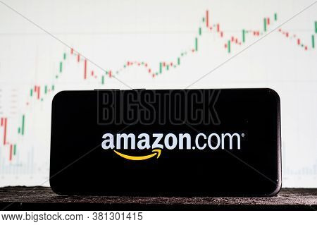 Tula, Russia - August 10, 2020: Logo Amazon On A Smartphone Against The Background Of Stock Market T