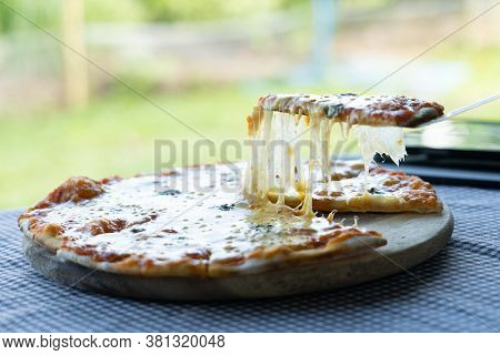 Homemade Pizza Made From Dough Topped With Spices Like Ham, Sausage And Vegetables Like Chili, Onion