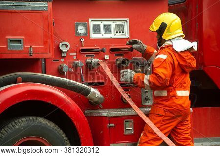 The Fireman Is Preparing To Put Out The Fire At The Fire Engine. Because The Fire Was Burning In The