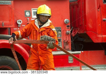 The Fireman Is Preparing To Put Out The Fire At The Fire Engine. Because The Fire Was Burning In The