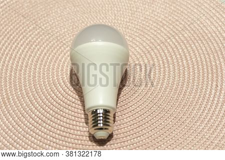 Peeled And Processed Rice Arranged In A Small Bowl. Wooden Scoop With Rice On A Blue Background. Hum