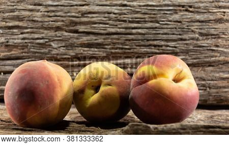 Peach Fruits (prunus Persica) In Natura On A Woody Background