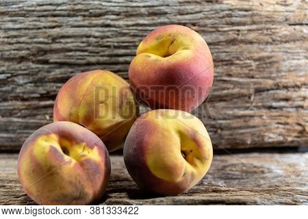Peach Fruits (prunus Persica) In Natura On A Woody Background