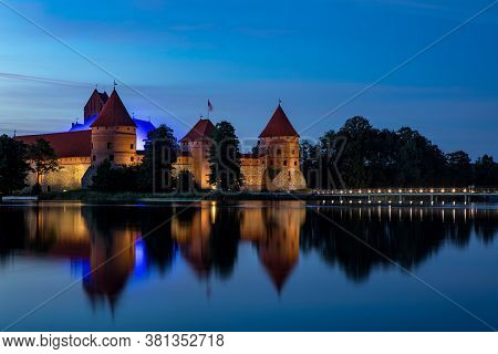 Trakai, Lithuania - July 14, 2020: Trakai Castle After Sunset In The Lake Galve. Trakai Castle Is On