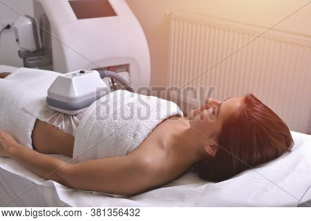 Beautiful Young Woman Getting Cryolipolyse Treatment In Cosmetic Cabinet