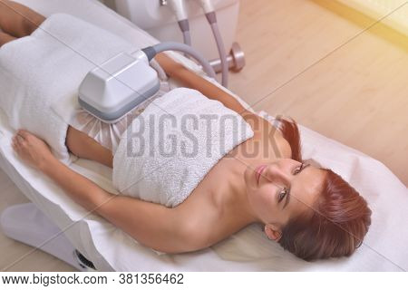 Beautiful Young Woman Getting Cryolipolyse Treatment In Cosmetic Cabinet