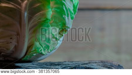 Head Of Fresh Cabbage (brassica Oleracea Var. Capitata) On Wooden Background