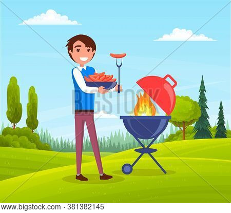 Happy Smiling Man With A Barbecue Tools Grill Sausages In Outdoor Landscape Summer Time. Person Cook