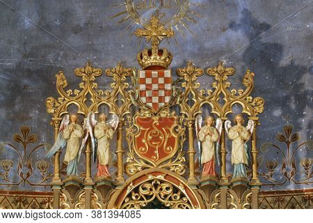 GRUBISNO POLJE, CROATIA - OCTOBER 01, 2011: Coat of arms of the Triune Kingdom of Croatia, Slavonia and Dalmatia surrounded by angels, altar in the church of St. Joseph in Grubisno Polje, Croatia