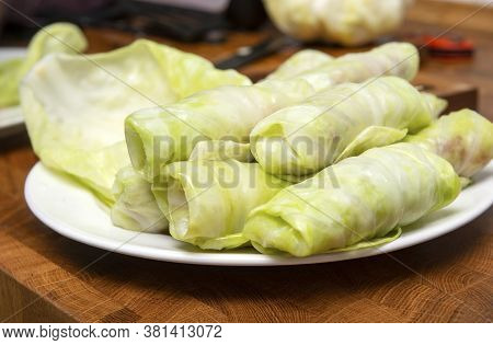 Raw Cabbage Rolls With Meat And Rice, Stuffed Cabbage On A White Plate