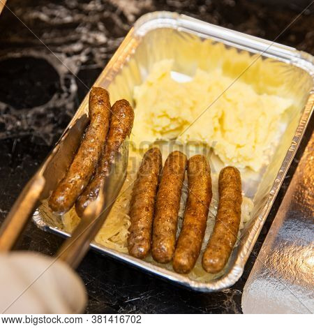 Chef Putting White German Sausages To The Box