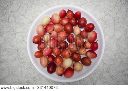 Indian Fruit Karaunda Known As Carissa Caranda Fruits Arranged In Circular Shape On White Background