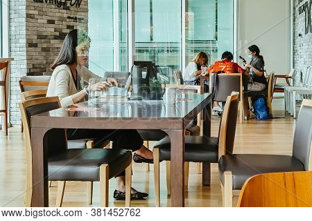 Bangkok-thailand, July 14, 2020: Unidentified Customers Work On Computer With Smartphone And Relax W