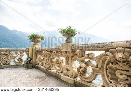 Villa Balbianello. Lake Como. Italy - July 19, 2019: Old Classic Balustrade with Flowers Pot on Villa Balbianello. Lake Como. Italy. Ancient Fence. Ancient Architecture Baroque.