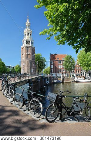 Montelbaanstoren Tower (built In 1516), Located Along Oudeshans Canal In Amsterdam Centrum, With A B