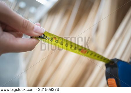 Construction Tape Line And Blurred Wooden Balks On The Background.