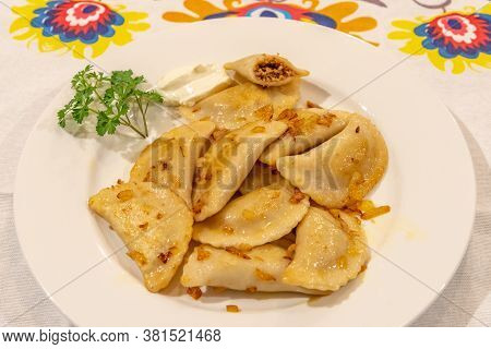 Pierogi Served On A Plate Ready For Eating With Lowicz Pattern Table Cloth