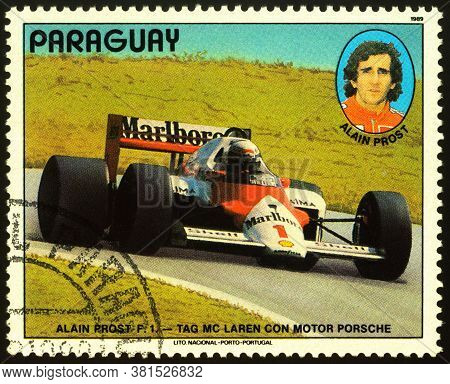 Moscow, Russia - August 18, 2020: Stamp Printed In Paraguay Shows Racing Car And Portrait Of French 