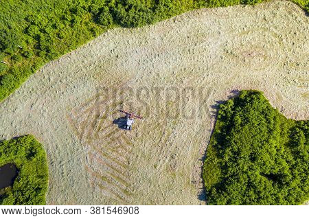 Top View Of Tractor With Tedders, Drying Mowed Hay