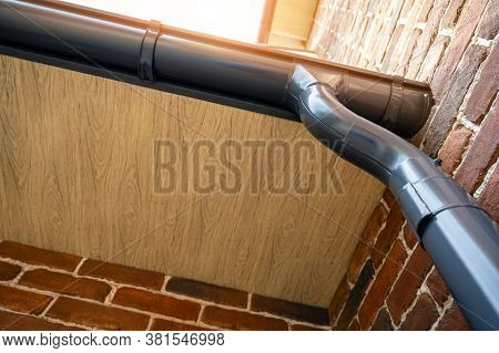 . Gutter System For A Metal Roof. Holder Gutter Drainage System On The Roof.