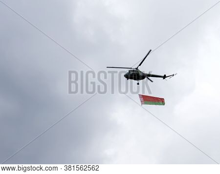 Helicopter Flies In The Sky With The Belarusian Redgreen Flag. Political Situation In Belarus. Selec