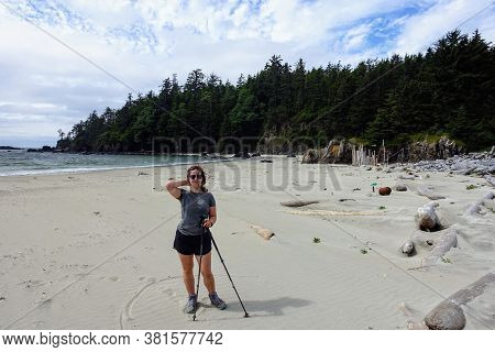 A Female Hiker Posing For A Photo By The Sandy Beaches Of Nels Bight And Experimental Bight, Beside 