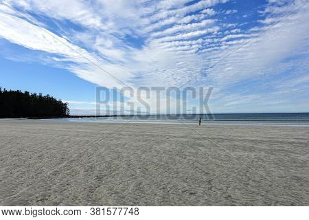 A Female Hiker Walking Along The Ocean Of The Sandy Beaches Of Nels Bight And Experimental Bight, Be