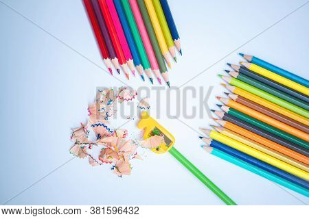 Back To School Concept. Top-down Of The Colored Pencils And Pencil Shavings Along With Yellow Pencil