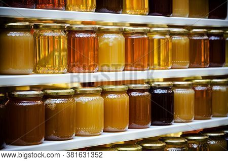 Jars Of Different Honey Varieties Stocked On A Shelf